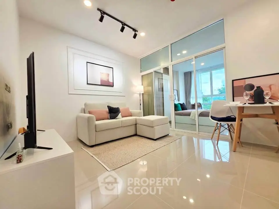Modern living room with sleek design, cozy sofa, and stylish decor in a bright apartment.