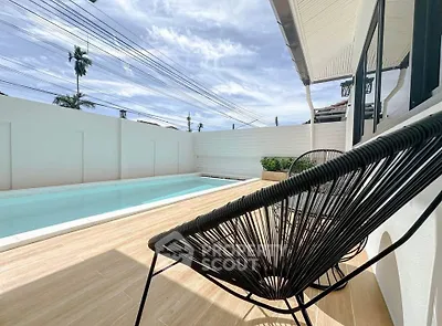 Stunning poolside view with modern patio seating and clear blue skies.