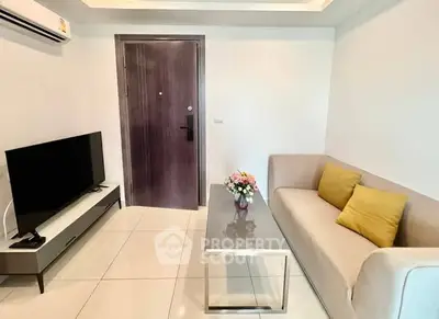 Modern living room with sleek furniture and flat-screen TV, perfect for relaxation.