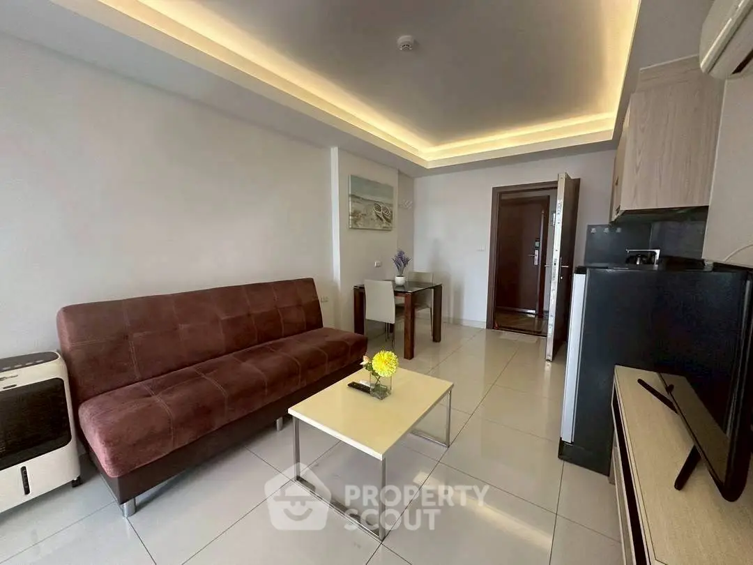 Modern living room with sleek furniture and ambient lighting in a stylish apartment.