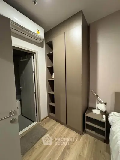 Modern bedroom with sleek wardrobe and air conditioning unit