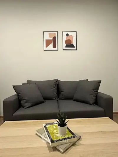 Modern living room with stylish gray sofa and minimalist decor