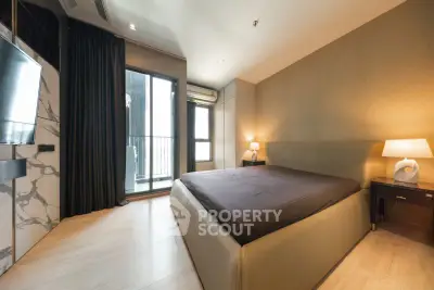 Modern bedroom with elegant decor and balcony access in luxury apartment