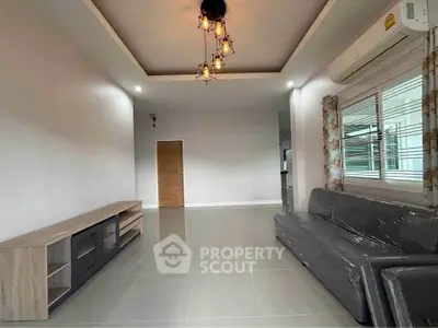 Spacious modern living room with stylish lighting and air conditioning, perfect for comfort and relaxation.