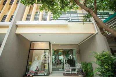 Charming townhouse exterior with modern design and lush greenery