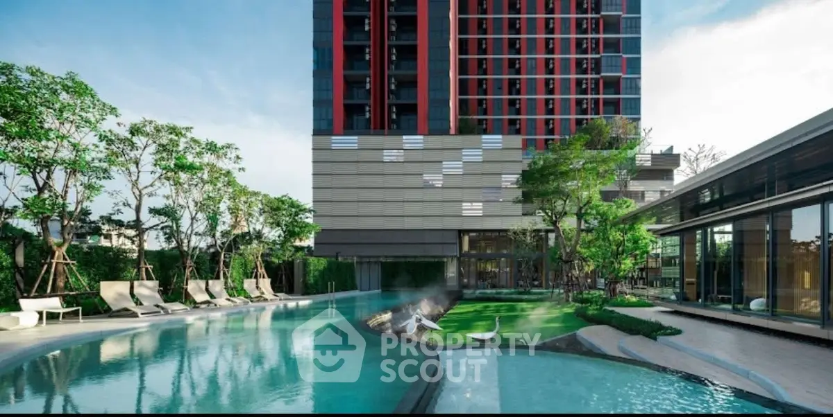 Luxurious modern apartment building with stunning pool and lush greenery