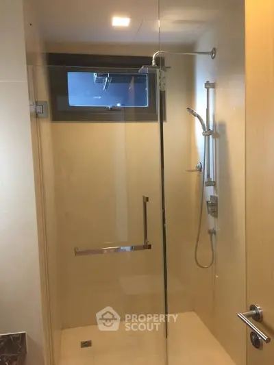 Modern bathroom with glass shower enclosure and sleek fixtures