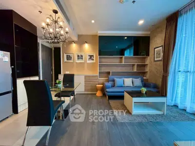 Stylish modern living room with elegant chandelier and cozy seating area.