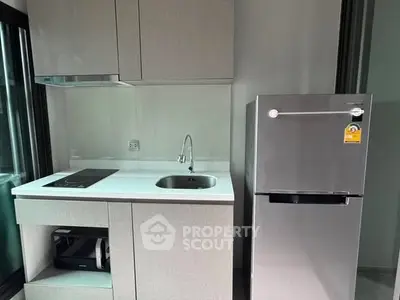 Modern compact kitchen with sleek appliances and minimalist design