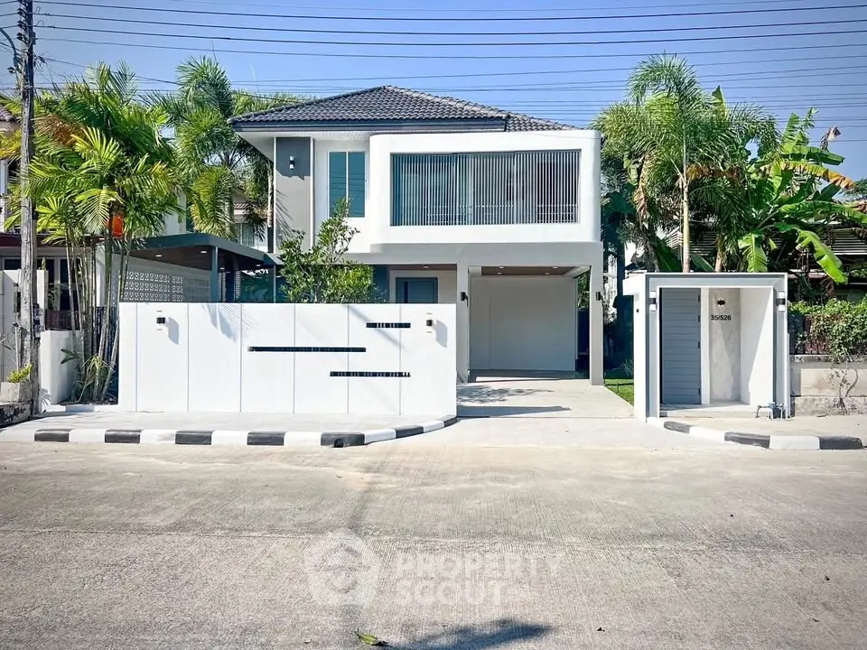 Modern two-story house with sleek design and lush greenery, featuring a spacious driveway and contemporary facade.