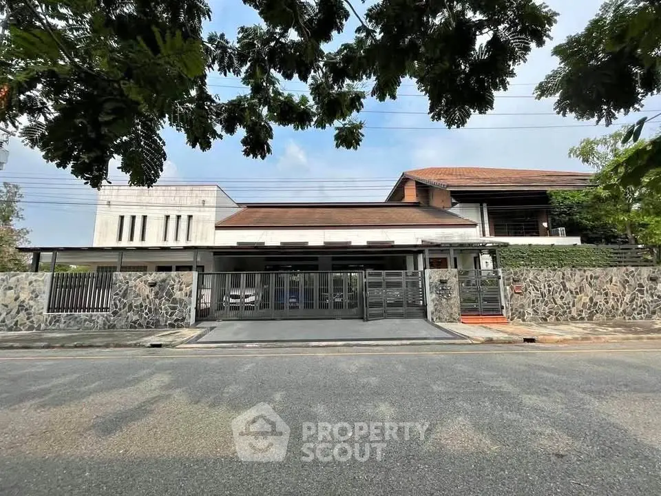 Stunning modern house with spacious driveway and lush greenery, perfect for luxurious living.