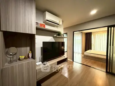 Modern living room with sleek wooden furniture and open view to cozy bedroom