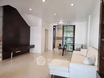 Spacious modern living room with sleek design and ample natural light