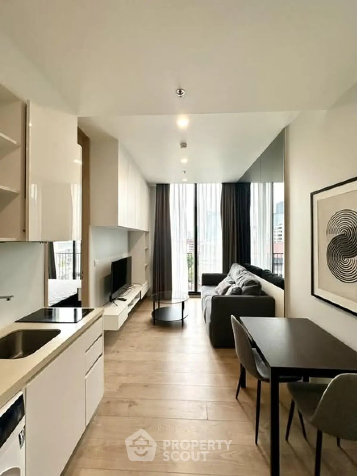 Modern living room with sleek design, open layout, and city view from large windows.