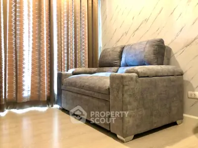 Cozy living room with stylish gray sofa and elegant curtains