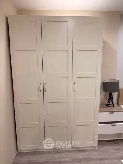 Modern bedroom with sleek wardrobe and stylish nightstand lamp