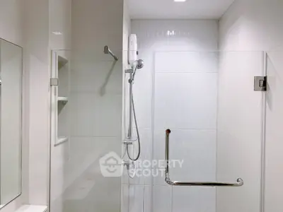 Modern bathroom with glass shower enclosure and sleek fixtures