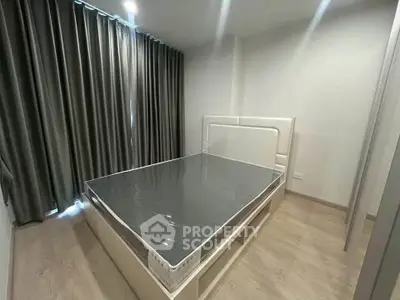 Modern bedroom with sleek design and ample natural light, featuring a stylish bed and elegant curtains.