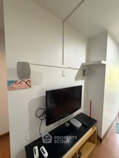 Cozy living room with wall-mounted TV and sleek black console, perfect for entertainment setup.