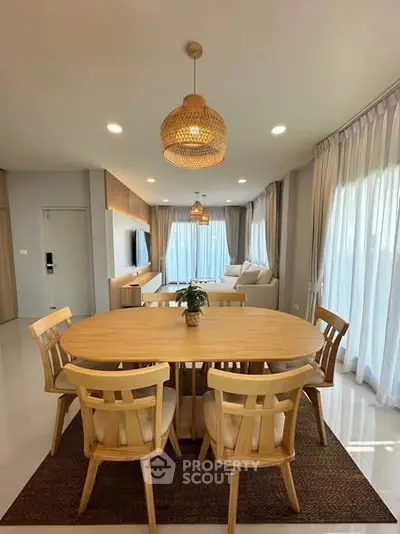 Spacious living room with elegant dining area and natural light