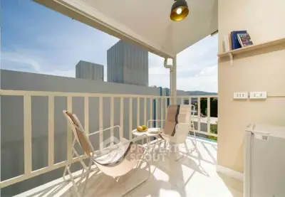 Charming balcony with seating and scenic view, perfect for relaxation and enjoying the outdoors.
