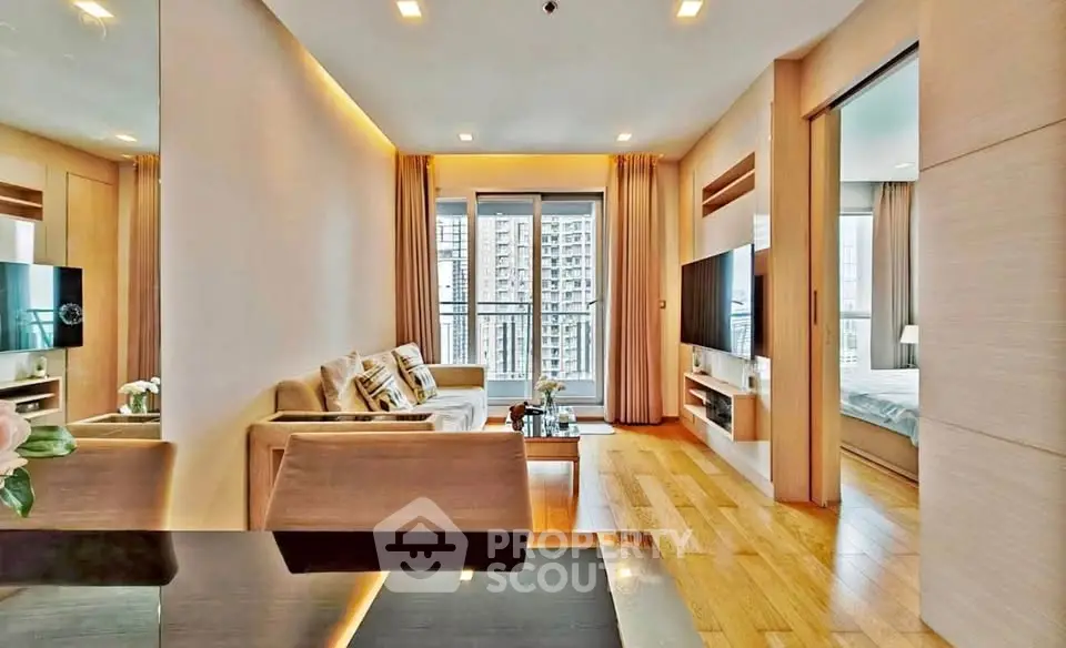 Modern living room with elegant decor and city view, featuring cozy seating and sleek entertainment setup.