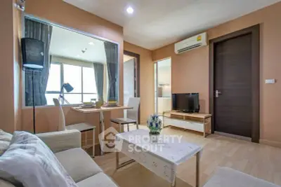 Modern living room with cozy seating and natural light in stylish apartment.