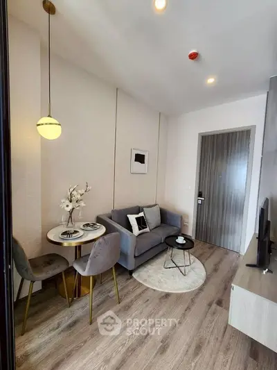 Modern living room with cozy seating and stylish decor in a contemporary apartment.