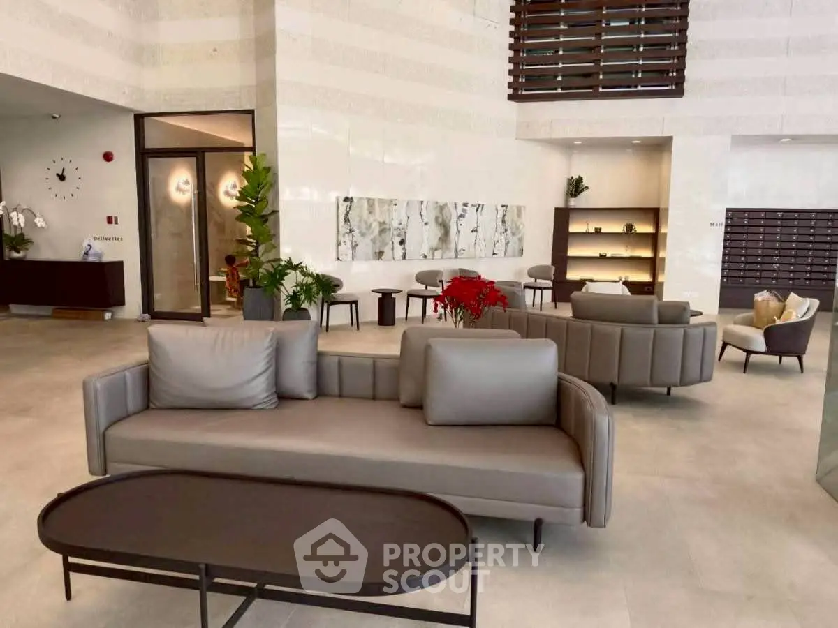 Luxurious modern lobby with elegant seating and contemporary decor in a high-end residential building.