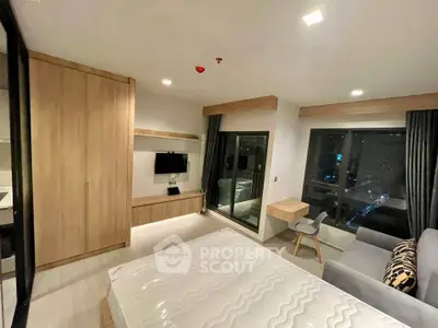 Modern bedroom with city view, featuring sleek furniture and large windows for natural light.