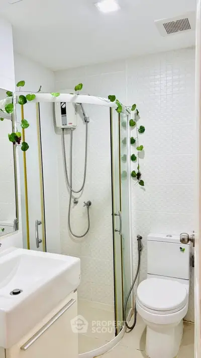 Modern bathroom with glass shower enclosure and white fixtures