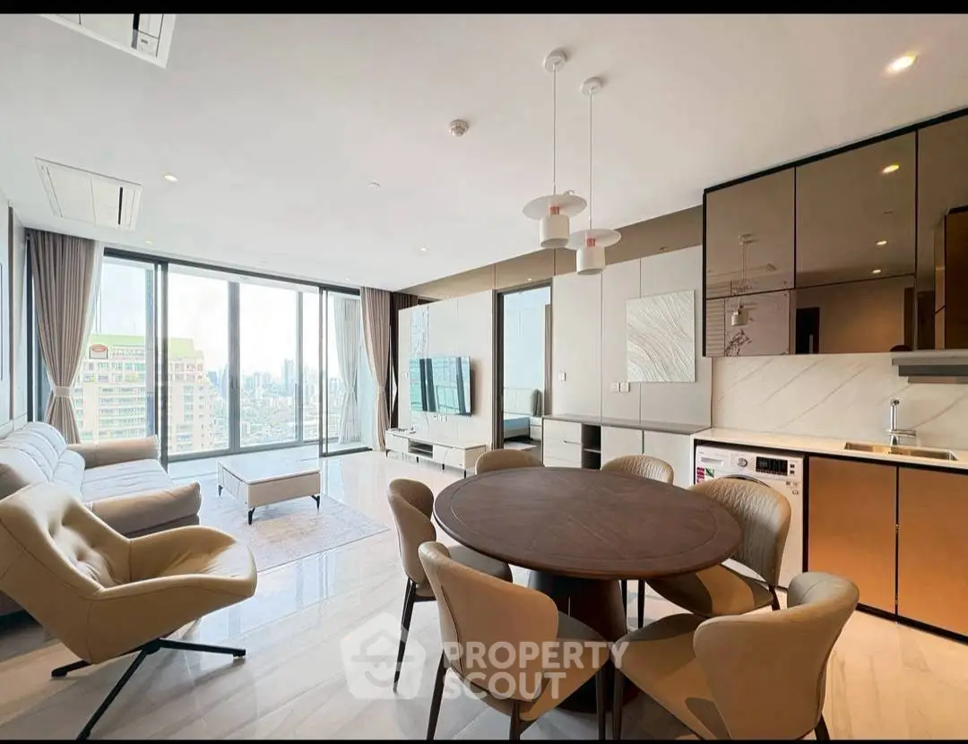 Luxurious modern living room with panoramic city views, elegant furniture, and open kitchen layout.