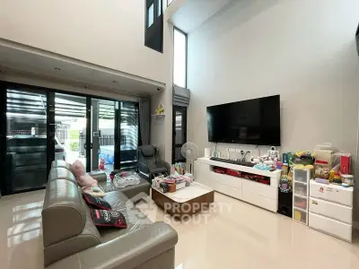 Spacious modern living room with high ceilings and large windows for natural light.