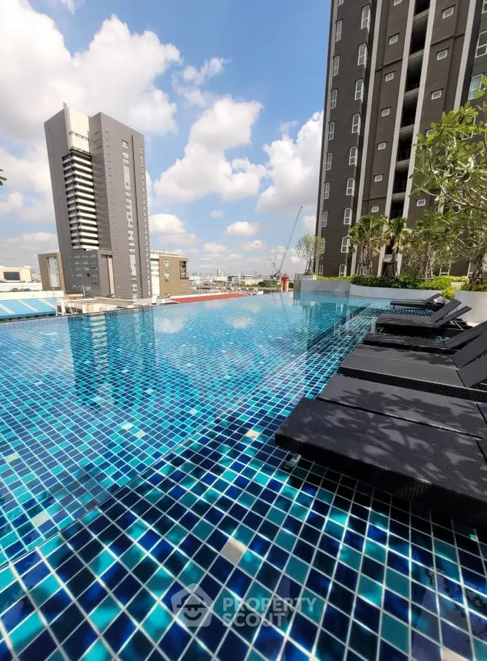 Luxurious rooftop pool with stunning city views and modern high-rise buildings.