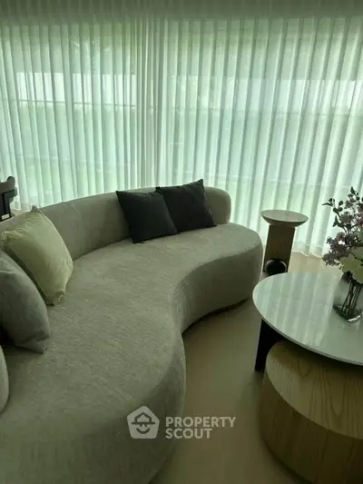 Elegant modern living room with curved sofa and stylish decor