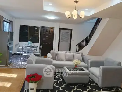 Spacious living room with modern furniture and dining area in a stylish home.