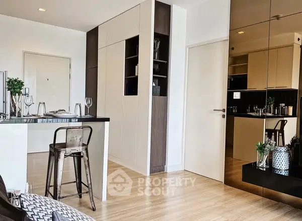 Modern open-layout kitchen with sleek design and stylish bar stools