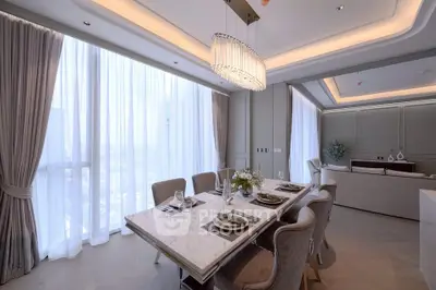 Luxurious dining area with elegant chandelier and marble table in modern apartment