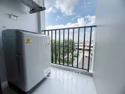 Modern balcony with washing machine and scenic view in urban setting