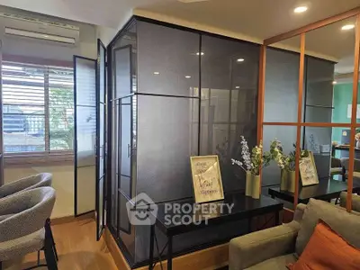 Modern living room with stylish glass partition and elegant decor