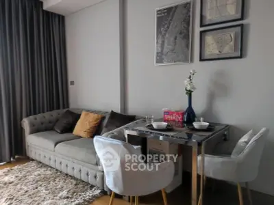 Stylish living room with elegant sofa and dining area, perfect for modern urban living.