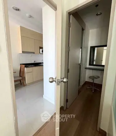Compact apartment interior with modern kitchen and cozy study nook