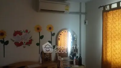 Cozy bedroom with air conditioning and sunflower wall decor