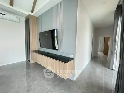 Modern living room with sleek TV unit and glossy tiled flooring