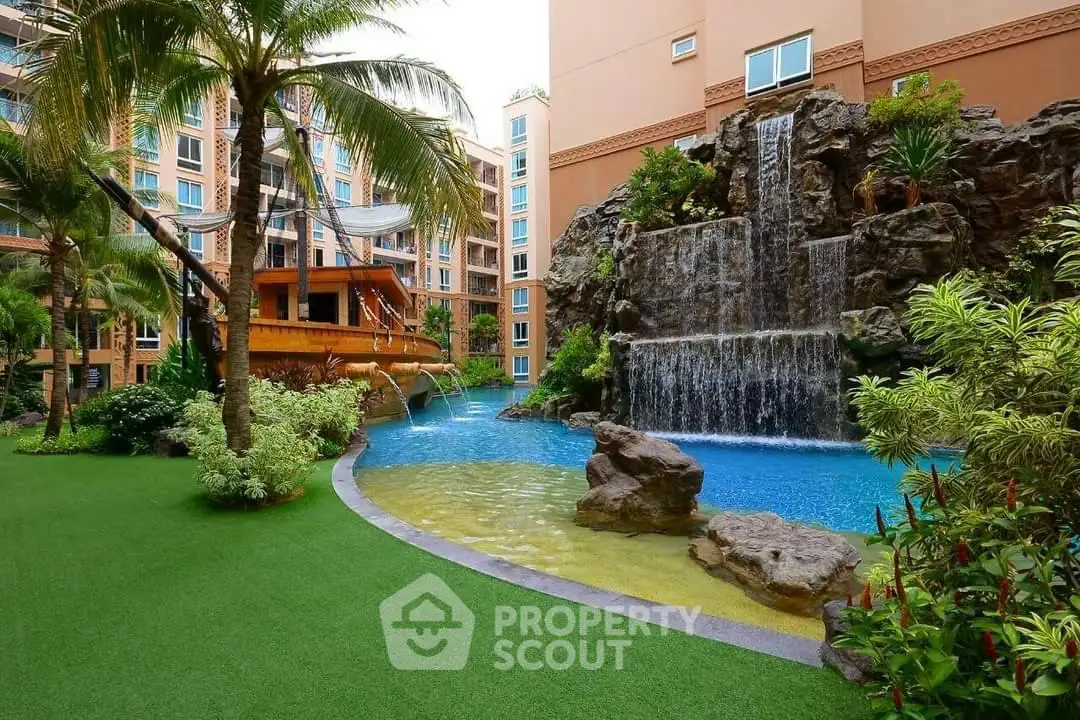 Luxurious apartment complex with stunning waterfall pool and lush landscaping.