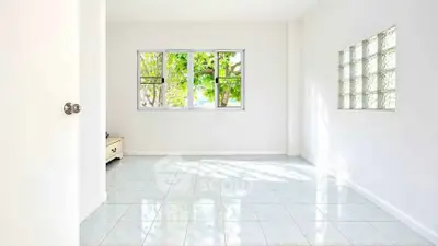 Bright empty room with large windows and tiled floor, perfect for customization.