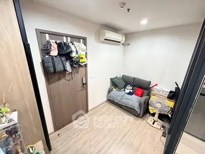 Cozy living room with modern air conditioning and compact sofa, perfect for urban living.