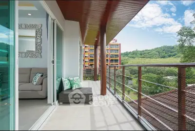 Spacious balcony with scenic view and modern interior design in luxury apartment.