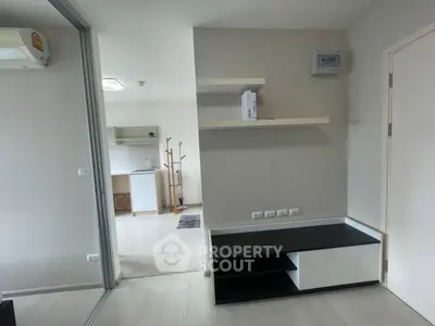 Modern apartment interior with sleek shelving and open kitchen layout