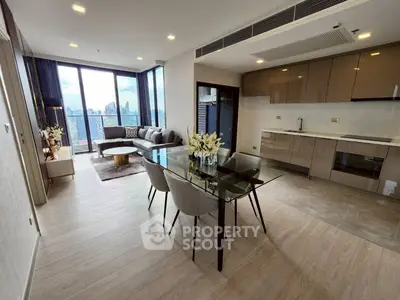 Modern open-layout living room with city view and sleek kitchen design